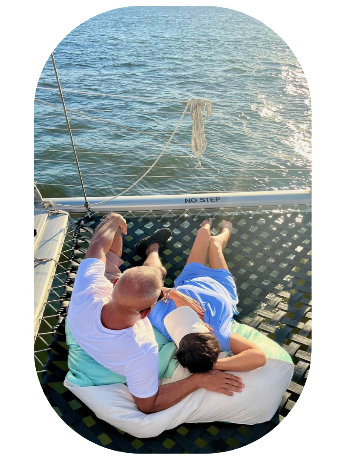 a man sitting next to a body of water