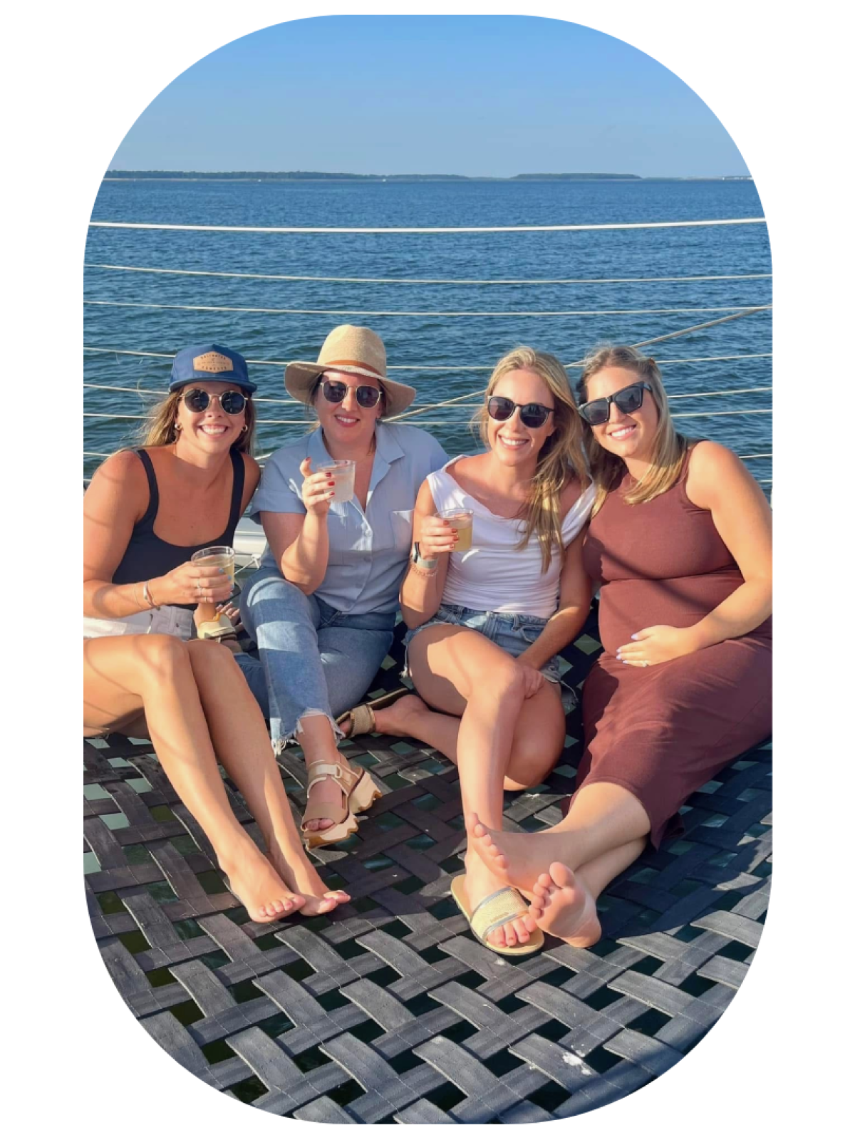 a couple of people that are sitting next to a body of water