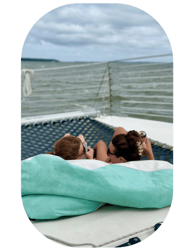 a person sitting on a bed next to a body of water